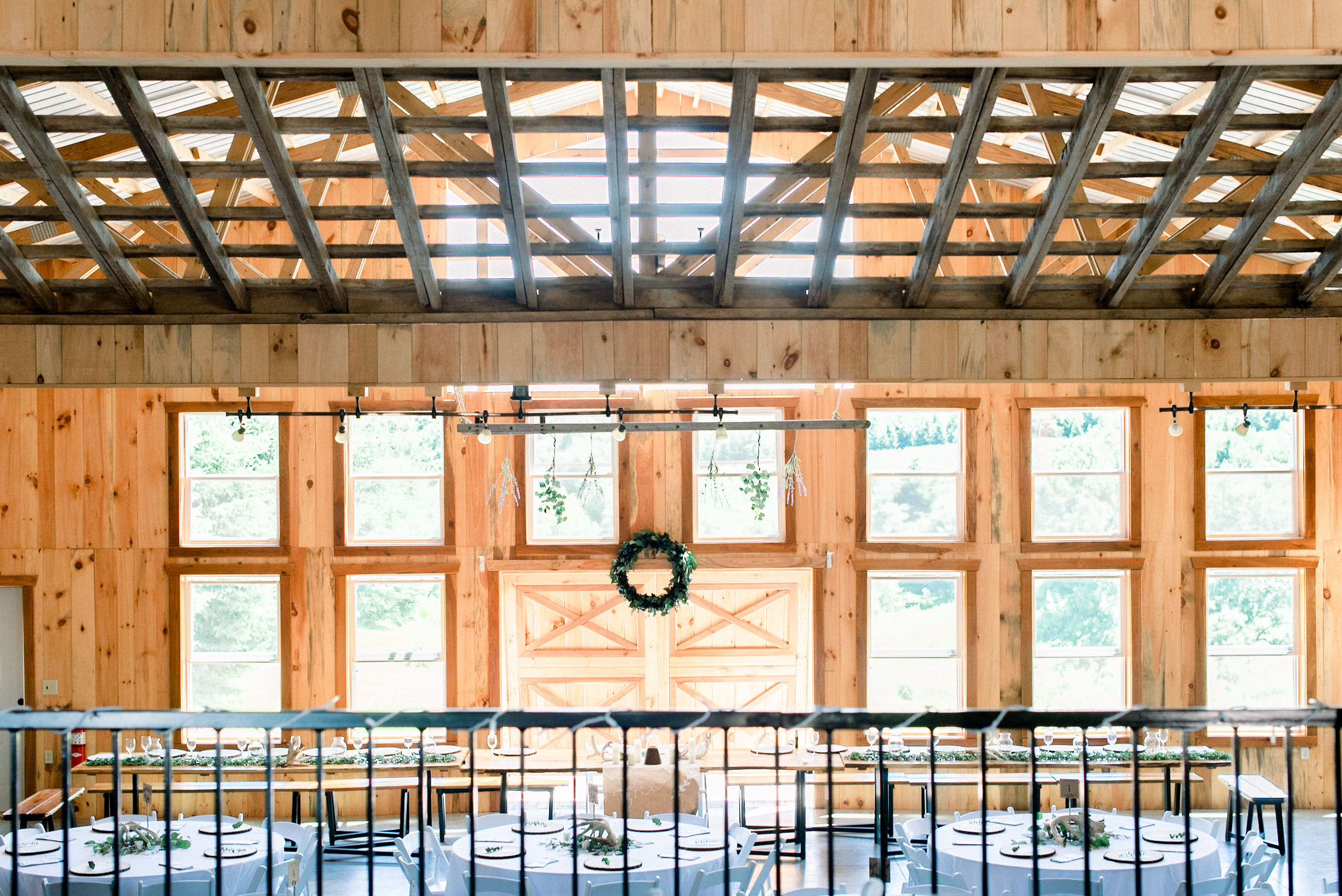 Interior of pavilion with lots of windows and light shining through exposed rafters